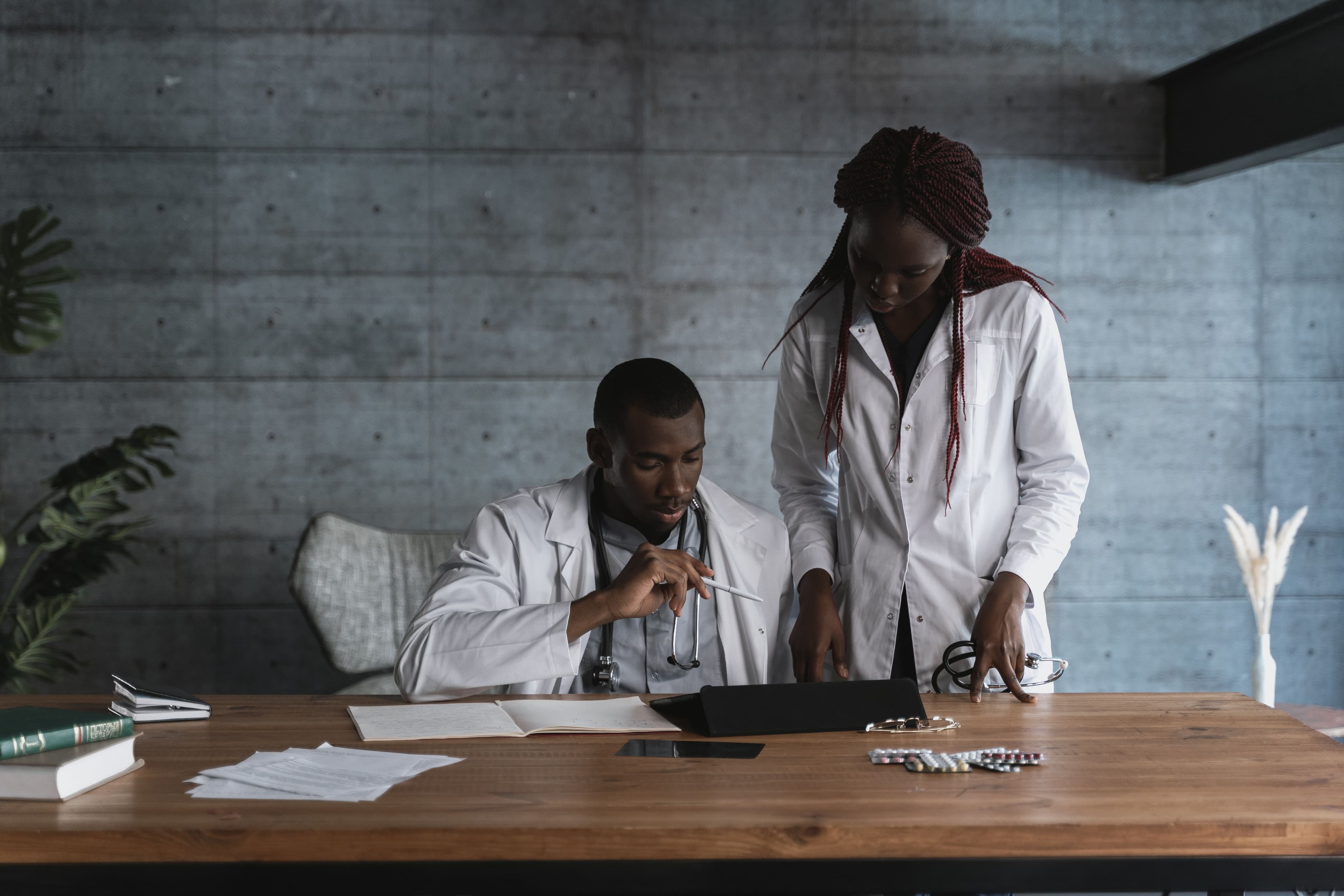 Two clinicians reviewing cases together at a desk