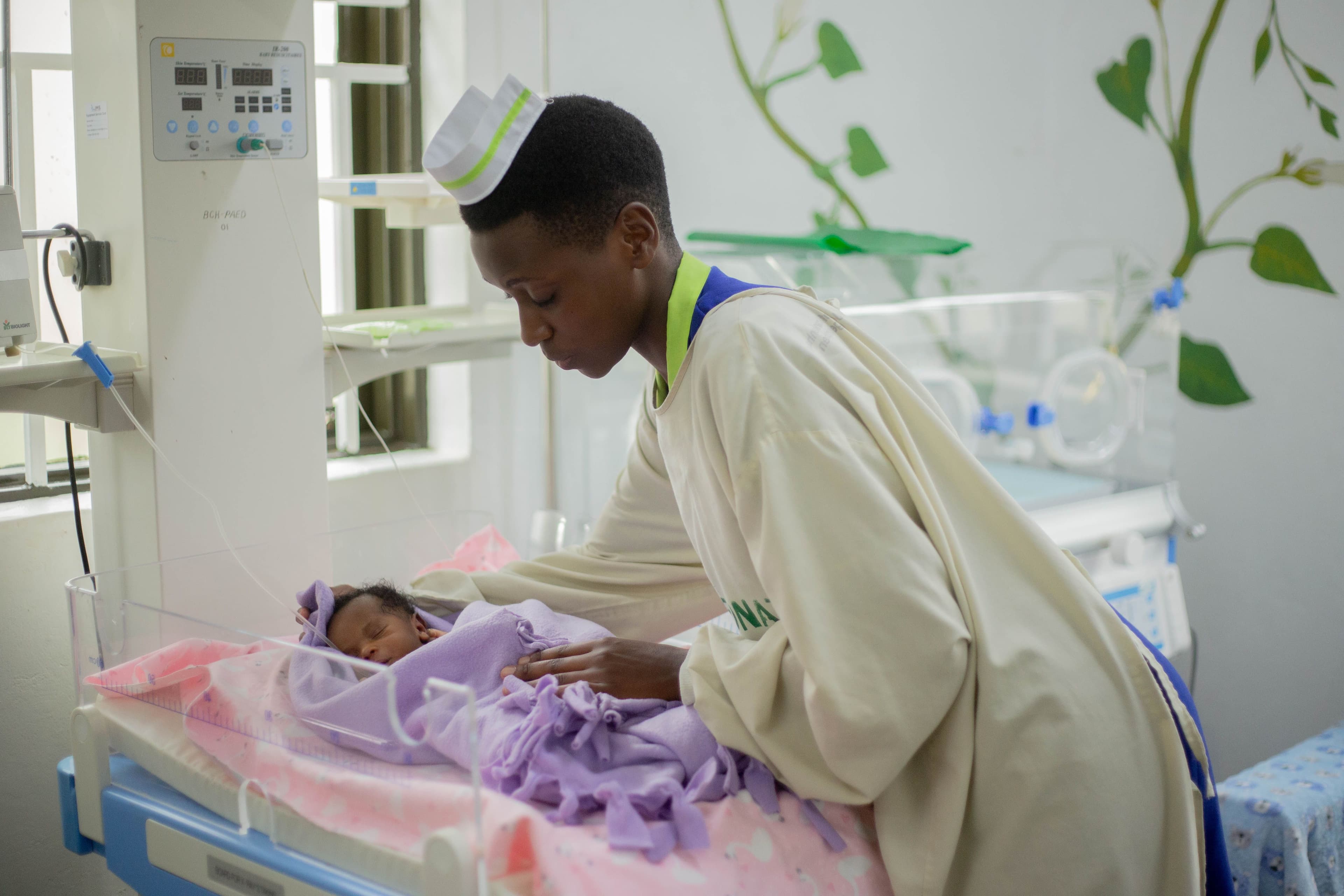 Nurse caring for a newborn in a neonatal unit